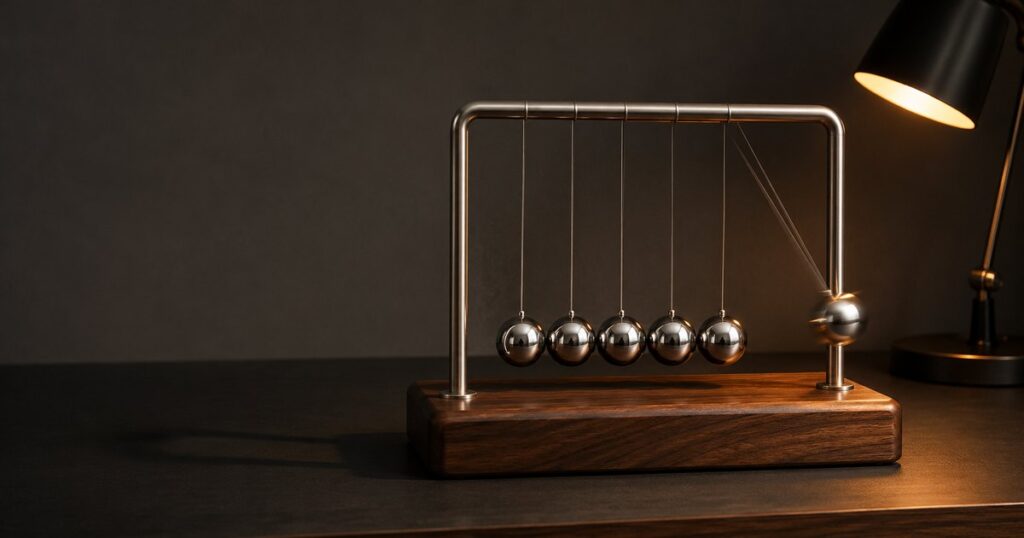 A polished chrome five-sphere Newton's cradle on a warm walnut base captured at the moment the impact has transferred through the three middle spheres and the rightmost sphere has just begun to swing outward, lit by a warm directional desk lamp against a soft graphite background - illustrating how an Action Over lawsuit passes through a third party and a contract back to the employer that the injured employee cannot sue directly.