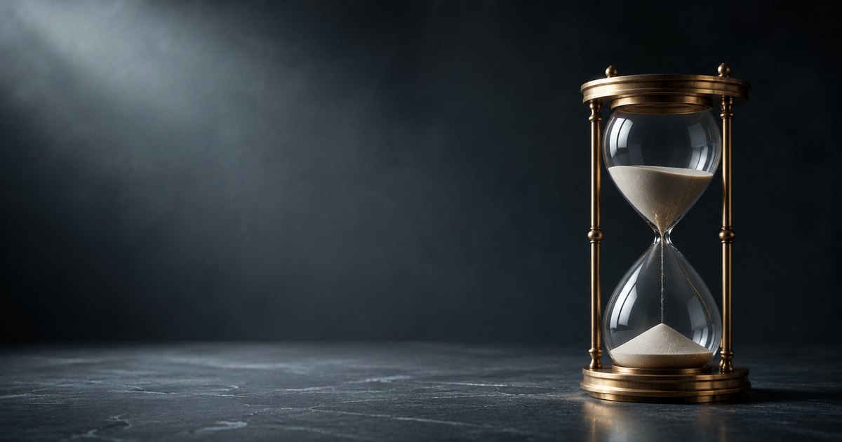 A polished brass hourglass with pale sand cascading between two chambers on a dark slate surface, illustrating how general liability per-occurrence and aggregate limits stack and erode across a policy year.